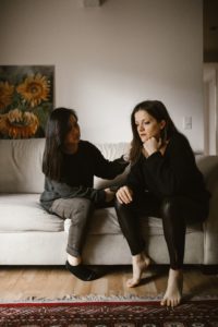 a friend helping comfort her friend who is in an abusive relationship