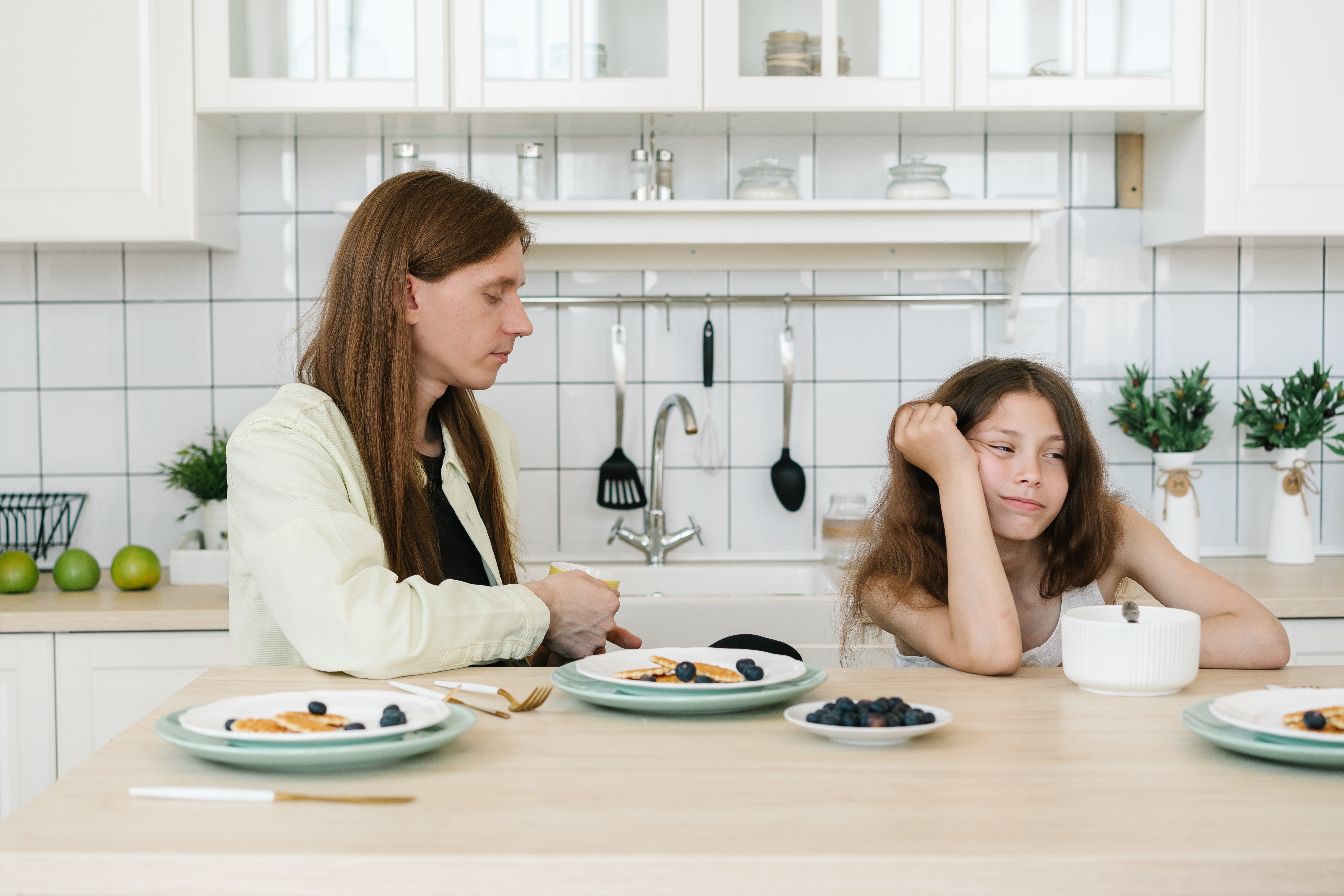 Mother and daughter fighting in kitchen - A supportive father providing a stable and loving environment for his daughter during a high-conflict divorce