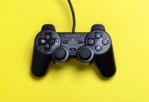 Play station controller against yellow background