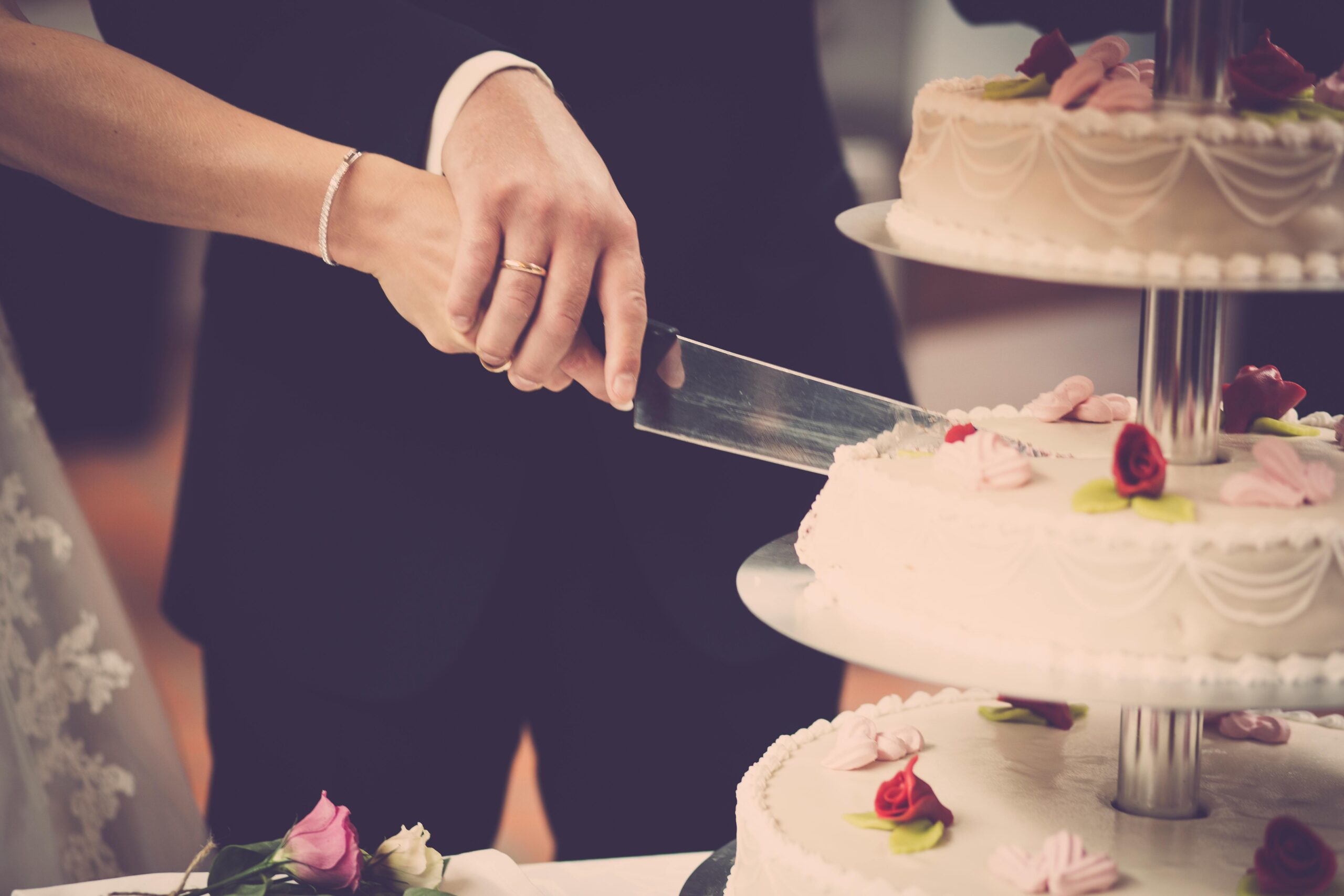 Man and wife cutting their wedding cake.
