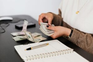 Woman counting dollar bills