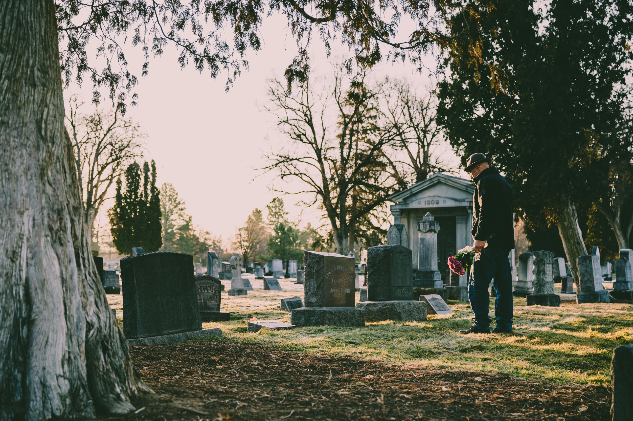 Person leaving flowers at grave