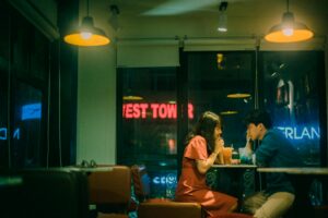 two people sitting at a restaurant on a date
