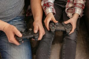 Parent and child playing video games together