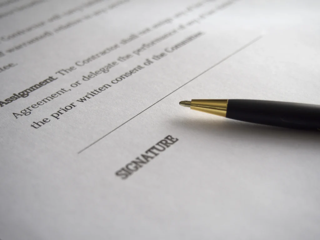 Utah child support enforcement agreement document with signature line and pen representing 2026 ORS enforcement changes.